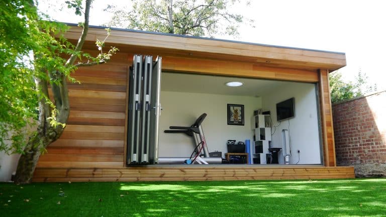 Modular eco building used as a Cycle training room and garden office with bi-fold doors and cedar cladding by TGEscapes