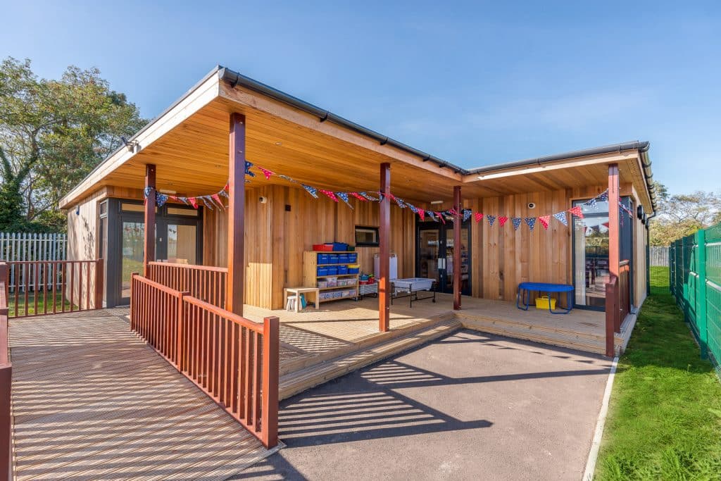 Modular Eco-Building at Rabbsfarm Primary School with decking and disabled access ramp by TGEscapes