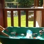 Children play on decking of Modular eco Classroom at Danesfield School by TGEscapes with cedar cladding