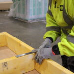 Man measuring wooden frame TG Escapes modular building