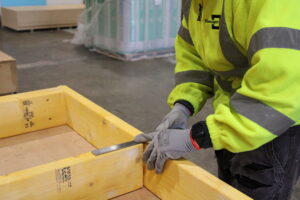 Man measuring wooden frame TG Escapes modular building